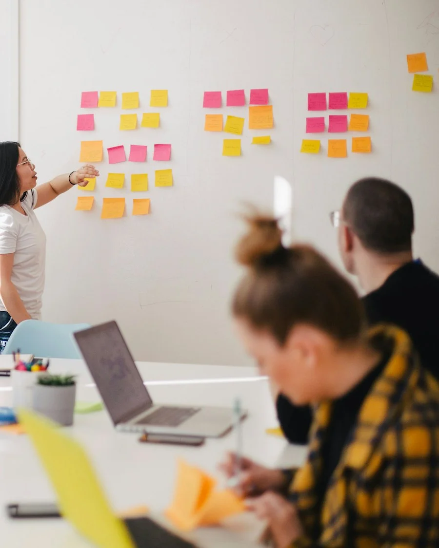 Team planning an IT strategy with sticky notes on a whiteboard