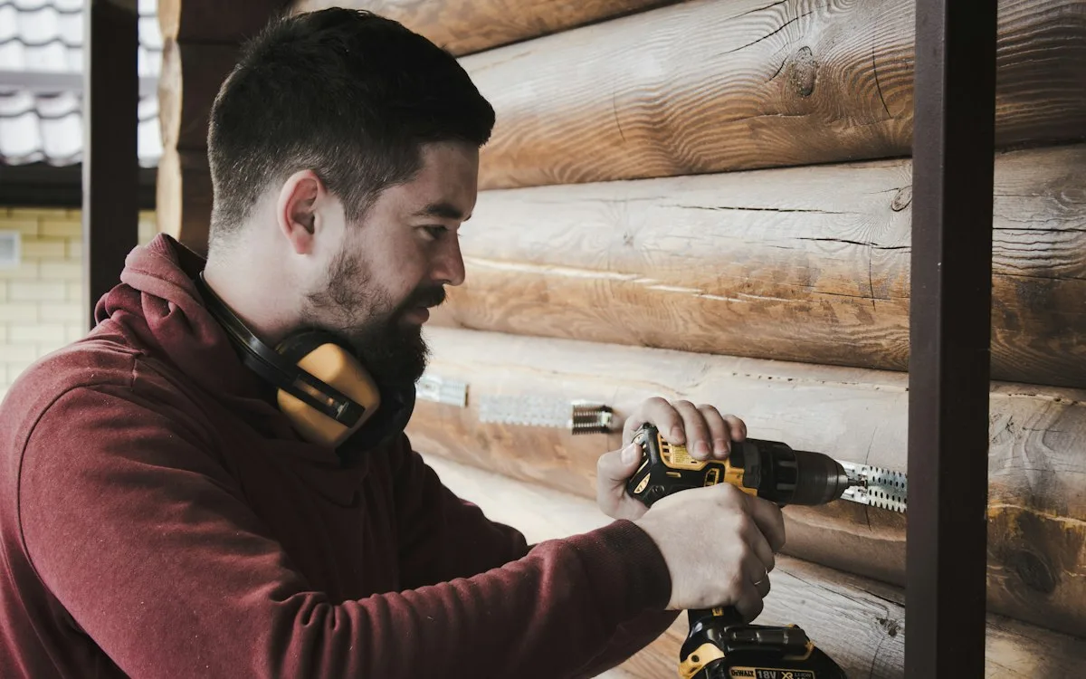 Worker using a power drill on site